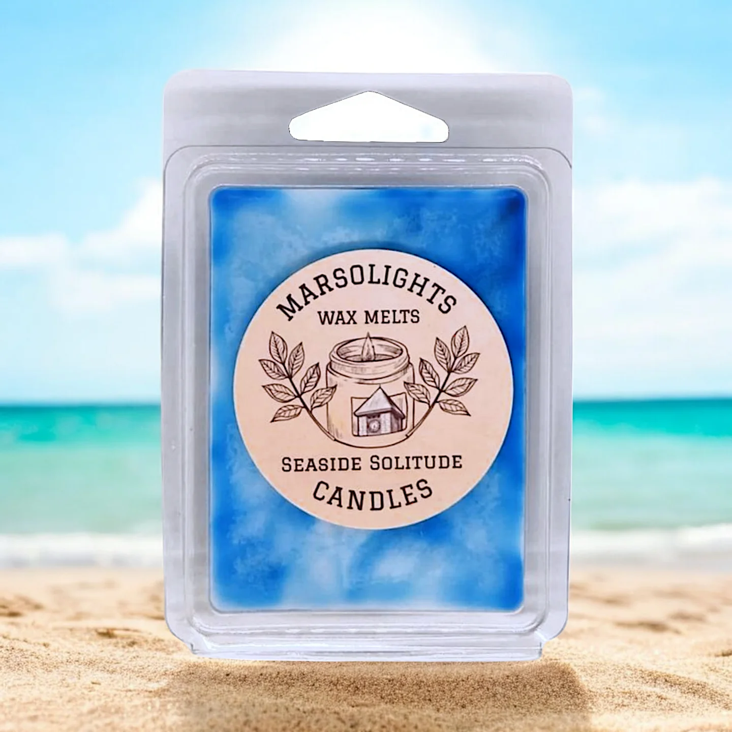 Seaside Solitude Wax Melt Blue on top of sand with the sun shining behind and the ocean in the background. Reminding you of the Fresh serene days of summer.