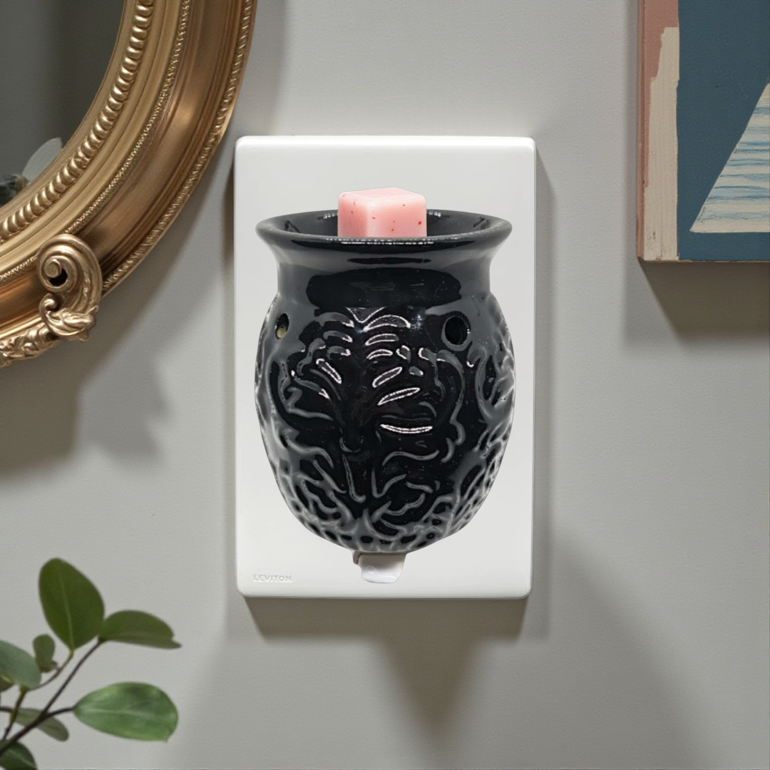 Black Floral Plug-In Wax Warmer, designed for convenient outlet use and a sleek, modern look. This compact warmer gently heats 1–2 cubes of Marsolights wax melts, releasing hours of consistent, welcoming fragrance without requiring counter space.
Dimensions: 4" × 5" = approximately 10.2 cm × 12.7 cm