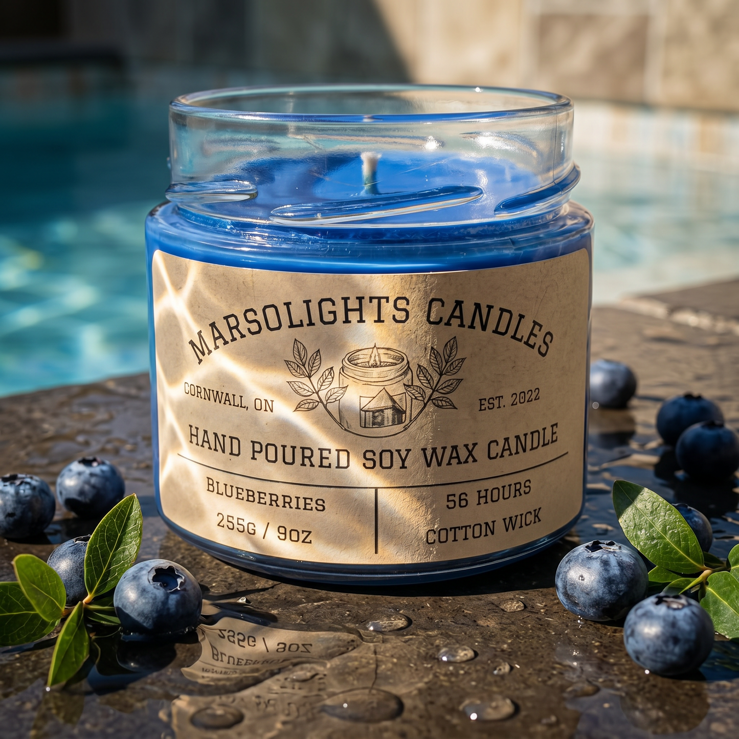 Blue candle in a glass jar with a label on a wooden surface surrounded by blueberries.

Label reads 56 hours for burn time
Wick is cotton 
Size if 255 grams or 9 oz
Blueberries Aroma Soy Scent Candle
by Marsolights Candles -Cornwall Ontario