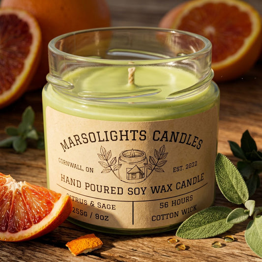 Citrus and Sage Soy Candle Sitting on a table with citrus and safe -  Orange, Sage, Bergamot & Eucalyptus Blend . 9 Ounces or 255 grams. 56 Hours Burn time. Cotton Wick. Made in Canada. 