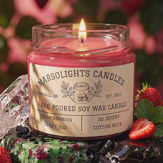 Fresh Strawberries Soy Candle displayed with fresh strawberry and fruit-inspired décor. The candle features ripe strawberries, zesty citrus, tropical pineapple, coconut water and a subtle hint of witch hazel. 9 ounce or 255 grams, 56-hour burn time, cotton wick, soy candle, made in Canada, phthalate free.