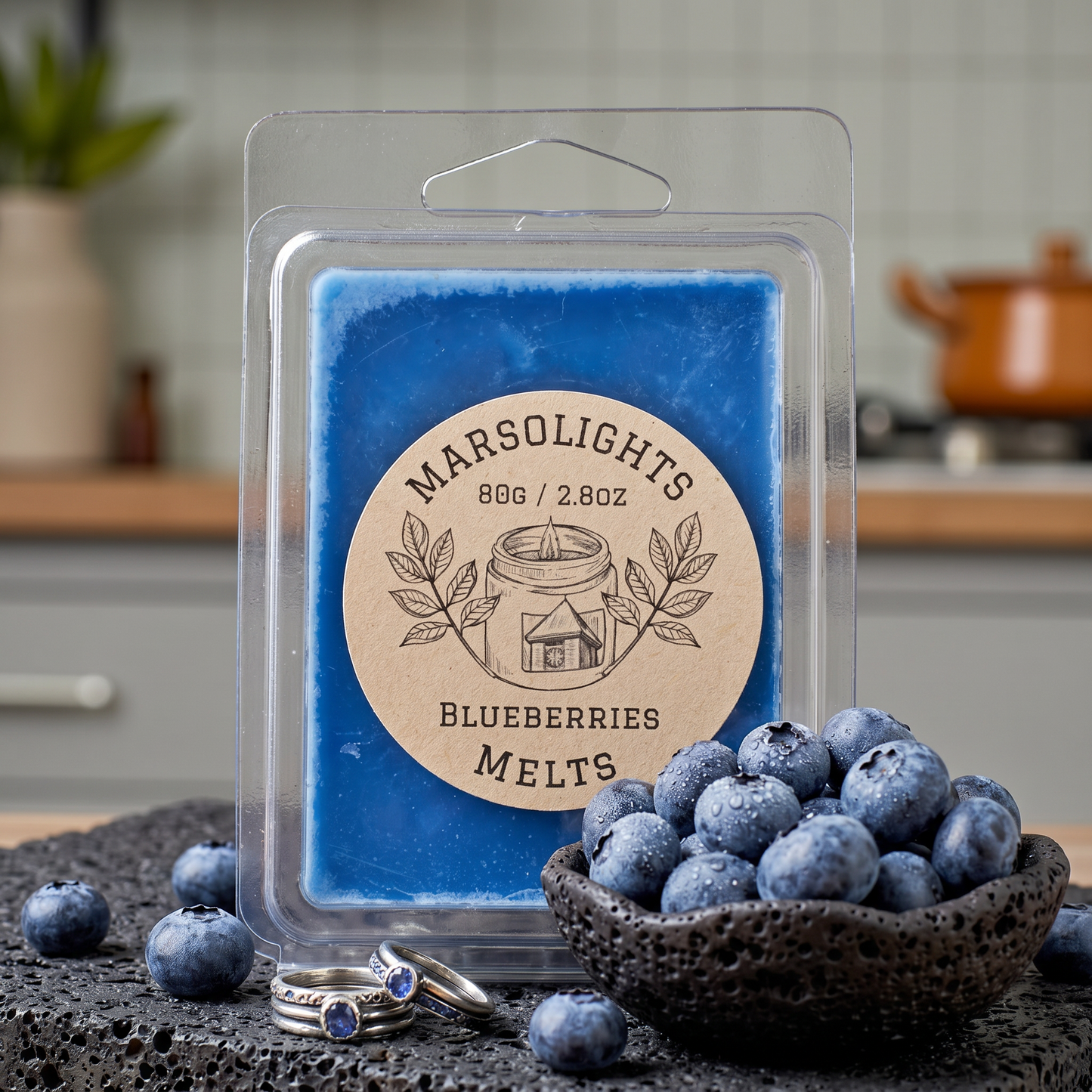 Blueberry-scented wax melts in packaging with 'Marsolights' branding, surrounded by blueberries on a kitchen counter.  6 Cubes, 2.8 ounce or 80 grams. Each cube lasts about 1-2 days. 